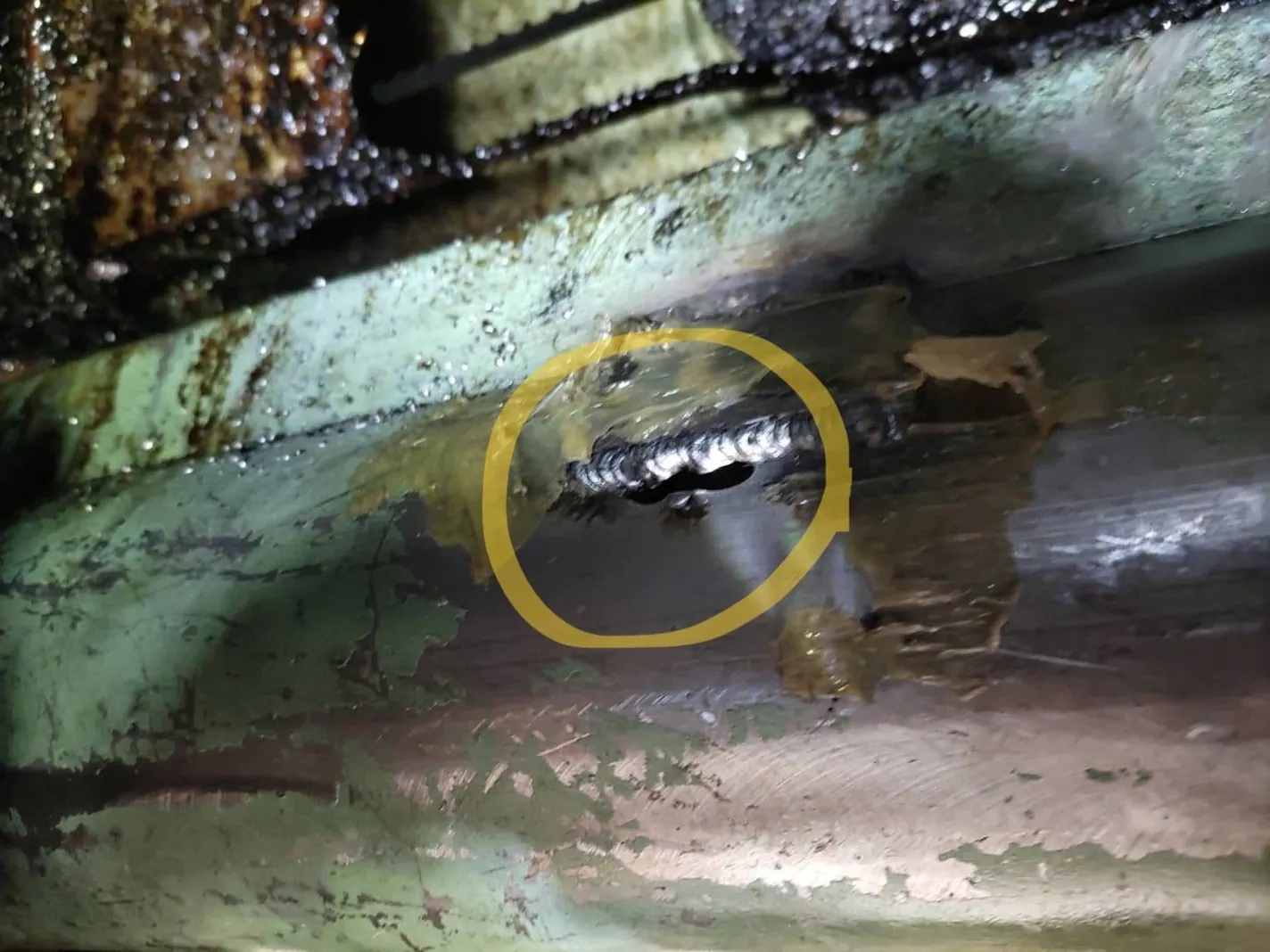 Hole in the screw conveyor leaking coolant